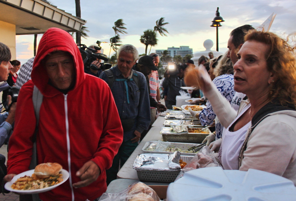 Arnold Abbott, the 90-year-old man who heads Love Thy Neighbor, along with other volunteers, helps feed homeless people in Fort Lauderdale, Fla., earlier this month.