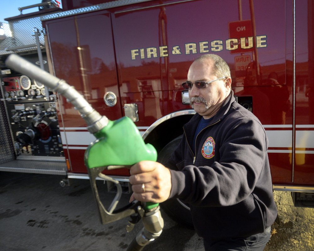 South Portland firefighter John Pallozzi finishes filling a vehicle with fuel Tuesday at the Public Works Department. The city uses about 135,000 gallons of fuel annually.