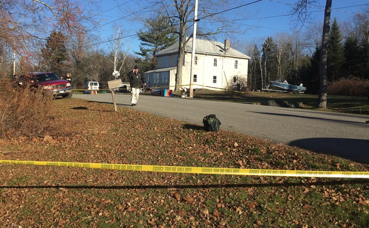 A Cumberland County Sheriff’s Deputy talks on a phone near the home on Long Island were the body of a man was found early Wednesday morning. David Hench/Staff Writer