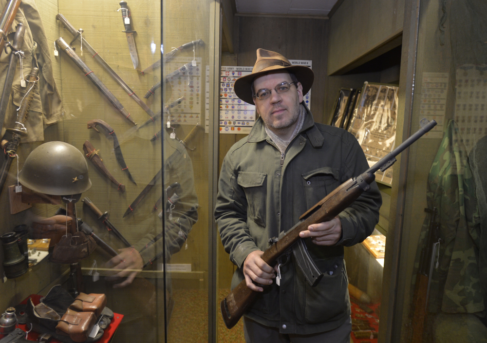 The Korean War-era M1 carbine held by Lynden Pioneer Museum director Troy Loginbill may seem an artifact, but since it’s post-1898, it’s affected by a new law.