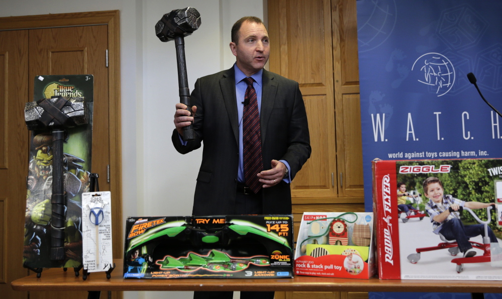 James Swartz, director of World Against Toys Causing Harm, holds up a toy battle hammer at the Children’s Franciscan Hospital in Boston on Wednesday.