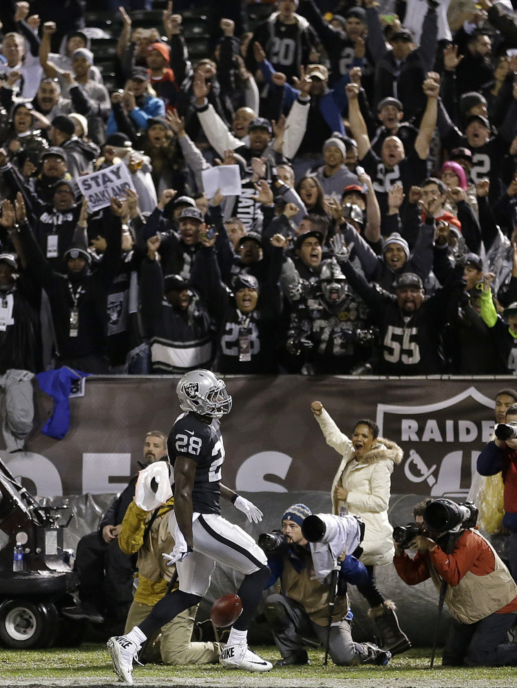 Fans cheer Thursday night as Latavius Murray of the Oakland Raiders scores on an 11-yard run against the Kansas City Chiefs in the first quarter of the Raiders’ 24-20 victory at home.