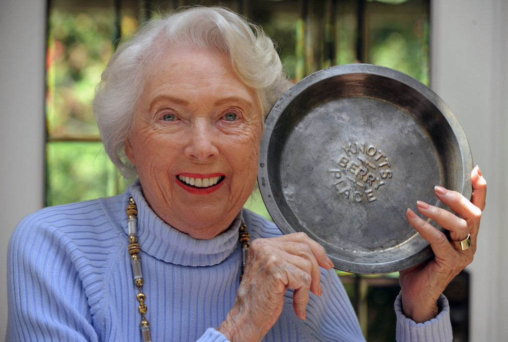 Marion Knott holds one of the original Knott’s Berry pie tins. The last surviving child of the theme park founders died at age 92.