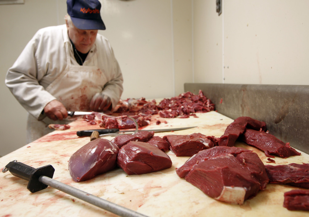 Everett Gage cuts steaks and roasts from deer following the first weekend of the deer rifle season in Loudon, N.H. Fish and Wildlife officials suspect that interest from local food connoisseurs is helping to level off a drop in the number of hunting license holders nationally.