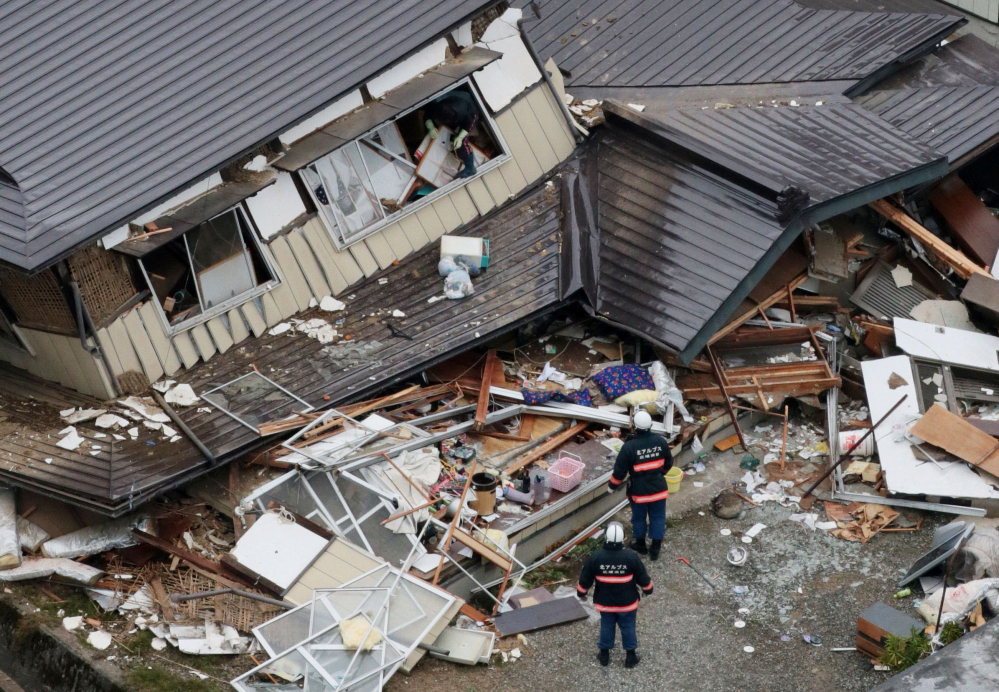 This aerial photo shows collapsed houses after a strong earthquake hit Hakuba, Nagano prefecture, central Japan, on Sunday. The magnitude-6.7 earthquake shook on Saturday night the mountainous area that hosted the 1998 Winter Olympics destroying more than half a dozen homes in the ski resort town.