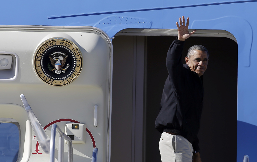 President Barack Obama waves as he boards Air Force One at McCarran International Airport, Sunday, in Las Vegas.
