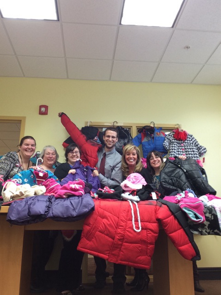 SIS Bank's South Sanford branch staff display some of the 45 coats they have purchased to donate to Coats for Kids.  From left are Sara Hammond, Debbra Springer, Katie Tarbox, Joey L’Heureux, Dee Richard and Theresa Jodway. Photo courtesy Deb Mullen