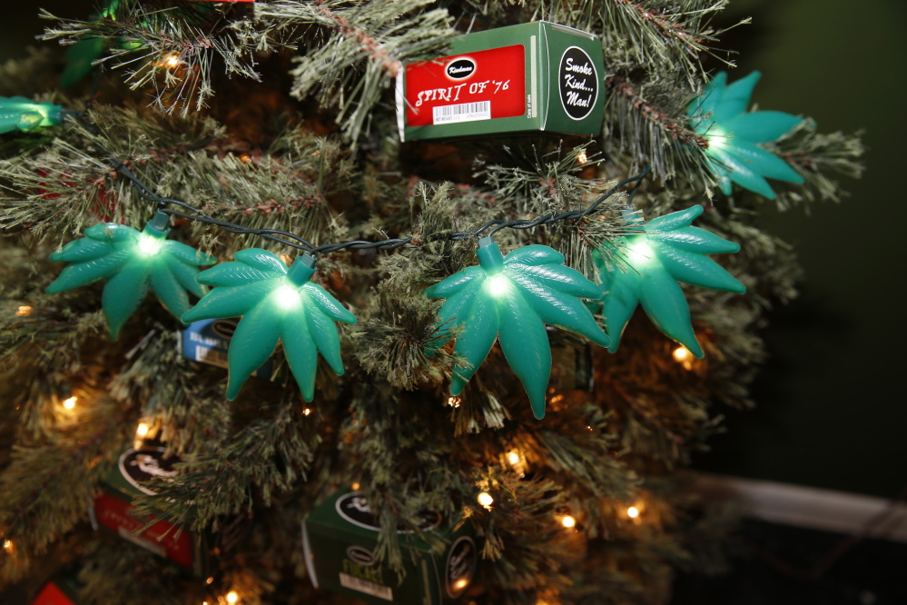 Plastic marijuana leaves light a Christmas tree as part of holiday display in a recreational marijuana shop in northwest Denver.