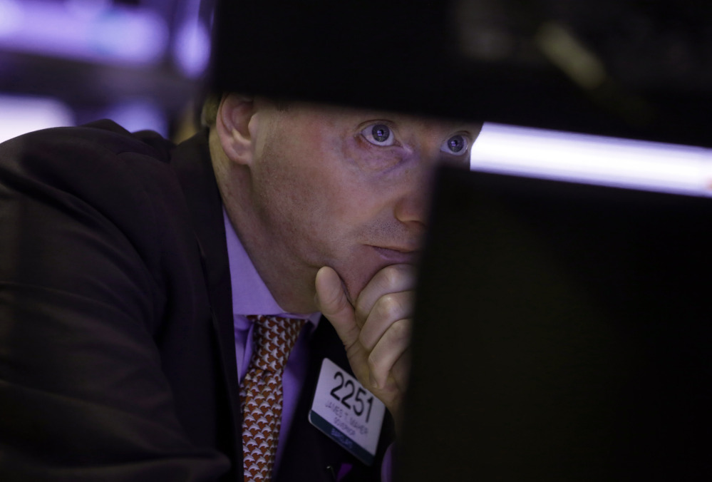 James Maher works on the floor of the New York Stock Exchange on Monday. Stocks rose with gains from Asian markets.