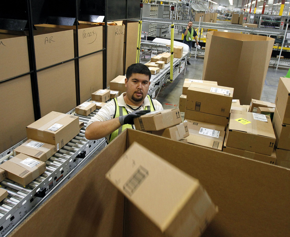 Ricardo Sandoval sorts packages at an Amazon.com center in Phoenix in 2010. Merchants are working hard to make same-day delivery a reality.