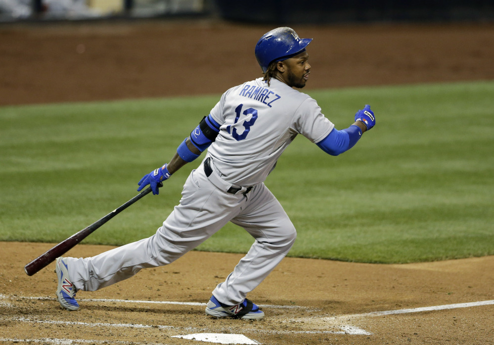 Los Angeles Dodgers’ Hanley Ramirez follows through after hitting an RBI-double against the San Diego Padres.
