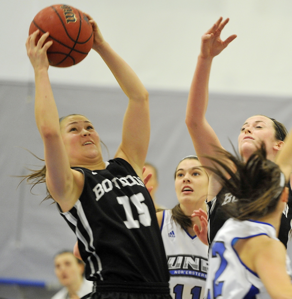 Marle Curle of Bowdoin pulls down the rebound Tuesday night during the non-conference game at the University of New England. UNE won the back-and-forth game, 68-64.