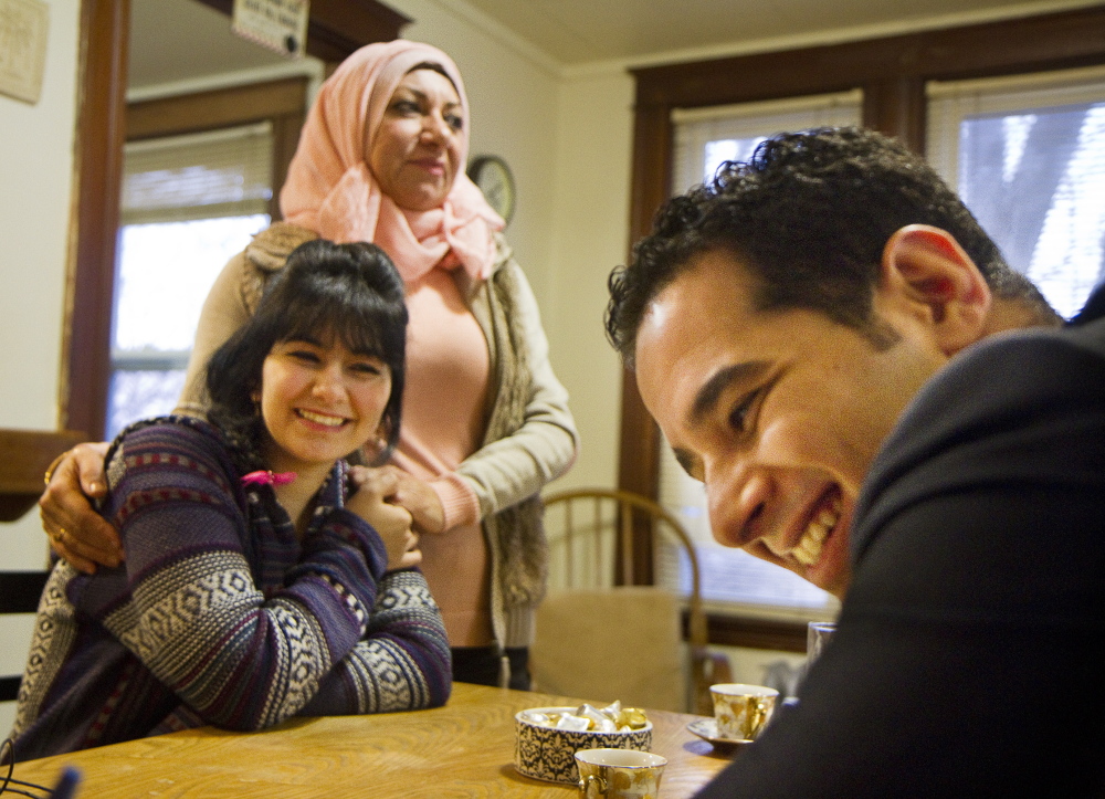 Ali Farid, right, served the U.S. and now gets to enjoy its freedoms along with his 15-year-old sister Mariam, center, and mother Dunya Al Obaidi, who will add some of their native land’s cuisine to the Thanksgiving feast.