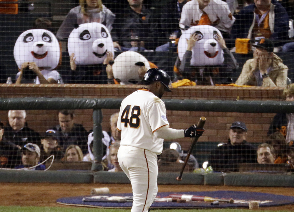 Pablo Sandoval walks past fans wearing panda heads during Game 4 of this year’s World Series at AT&T Park in San Francisco. With Sandoval’s departure to the Boston Red Sox this week, Giants fan Sam Li says he and his friends have decided to find a new way to honor their home team.
