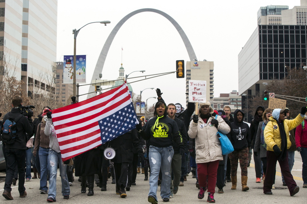 Demonstrators march to City Hall in St. Louis, Mo., on Wednesday as they protest a grand jury’s decision not to indict white police officer Darren Wilson for killing unarmed black teenager Michael Brown, 18, in the St. Louis suburb of Ferguson.