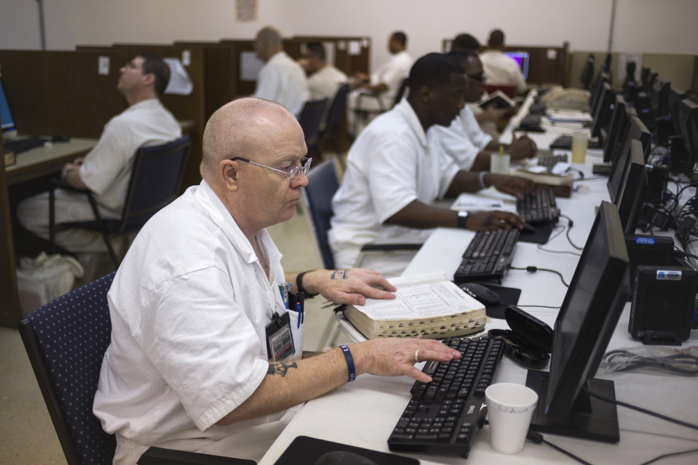 Inmates do academic work in a computer lab in a prison in Rosharon, Texas. Formerly known for being tough on crime, Texas now draws attention for reversing the explosive growth of its inmate population.