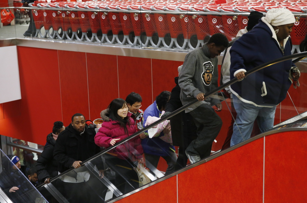 Thanksgiving Day shoppers ride an escalator at a Target store in Chicago. As the lines blur between in-store and digital shopping, retailers say they must win over these shoppers if they are to thrive in a fast-changing retail landscape.