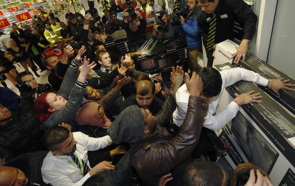 London shoppers compete to purchase items on Black Friday at an Asda superstore in Wembley.