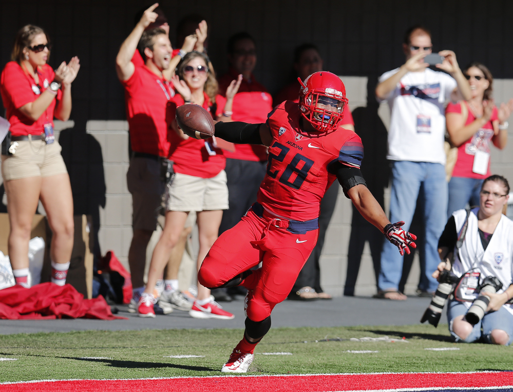 Arizona safety Anthony Lopez celebrates after recovering a fumble for a touchdown during the first half of Friday’s game against Arizona State in Tucson, Ariz.