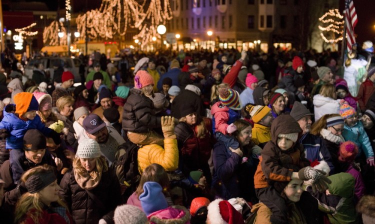 A crowd gathers for the Christmas tree lighting festivities in Portland’s Monument Square on Friday.