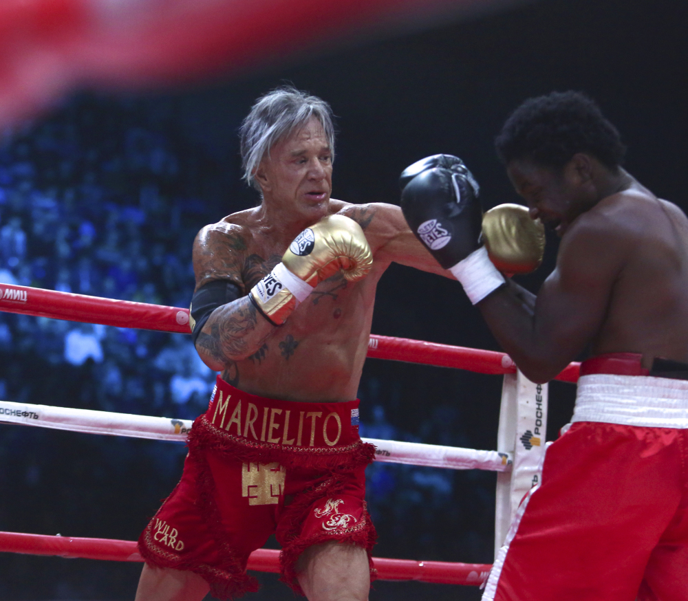 Actor Mickey Rourke, left, punches his opponent Elliot Seymour during his return to boxing in Moscow on Friday.
