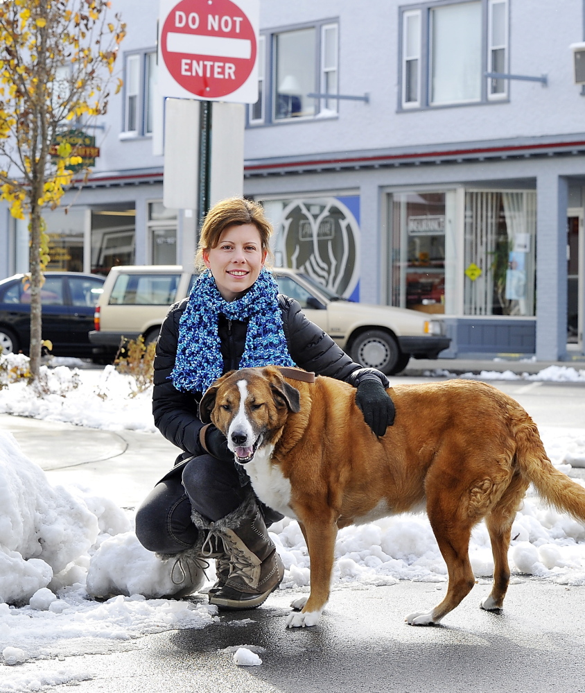 Melanie Wiker, a resident of South Portland’s Knightville neighborhood, seen with her dog, Hamilton, wants city officials to reopen a one-way section of Ocean Street to two-way traffic.