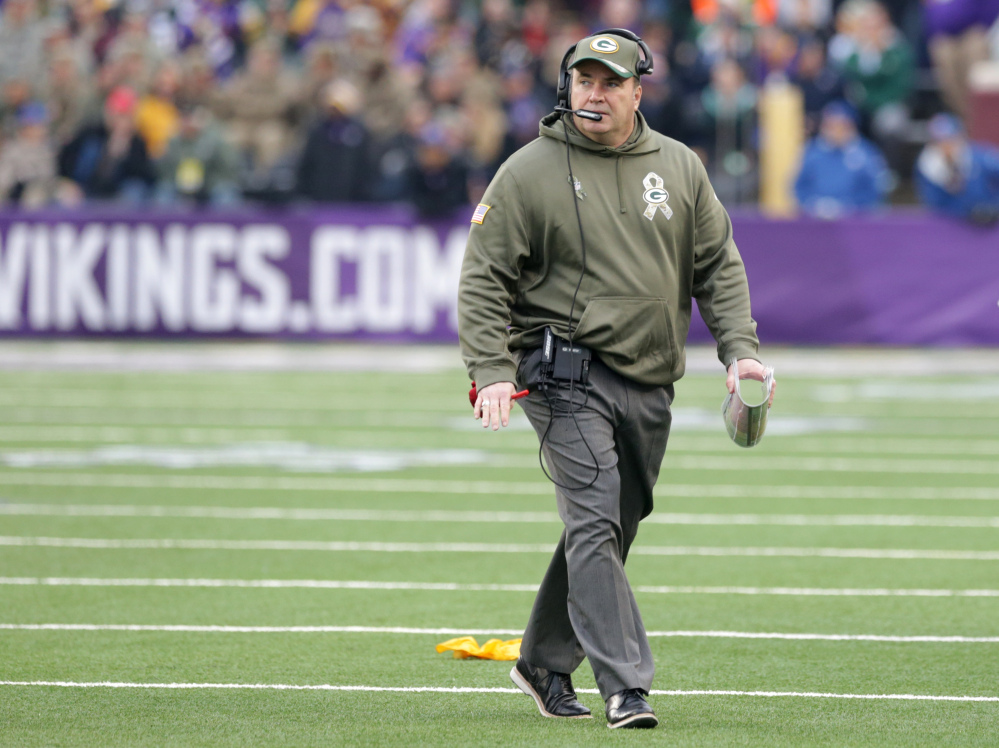 Green Bay Packers head coach Mike McCarthy walks on the field during the first half of an NFL football game against the Minnesota Vikings, Sunday, Nov. 23, 2014, in Minneapolis. (AP Photo/Jim Mone)