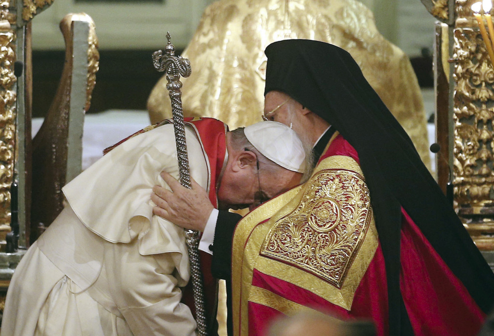 Pope Francis, left, bows to Ecumenical Patriarch Bartholomew I during an ecumenical prayer at the Patriarchal Church of St. George in Istanbul on Saturday. The two major branches of Christianity represented by Bartholomew and Francis split in 1054 over differences on the power of the papacy. The two spiritual heads participated in an ecumenical liturgy and signed a joint declaration in the ongoing attempt to reunite the churches.