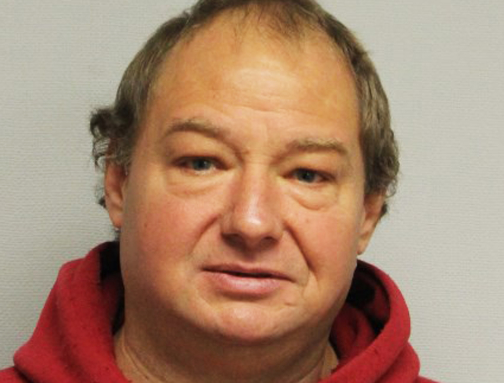 This undated photo provided by the Portsmouth Police Department, in New Hampshire, shows Roger Pelletier, who has been charged with felony counts of burglary and cruelty to animals, as well as simple assault after he tried to strangle his neighbor’s barking dog but ended up getting bitten and arrested.