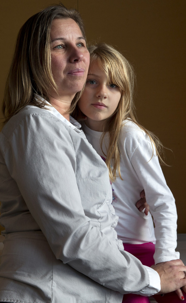 Peggy Young of Lorton, Va., holds her 7-year-old daughter, Triniti. The Supreme Court will hear her case Wednesday.
