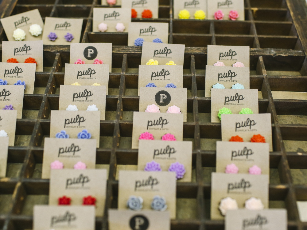 Earrings are displayed by a small business named Pulp.