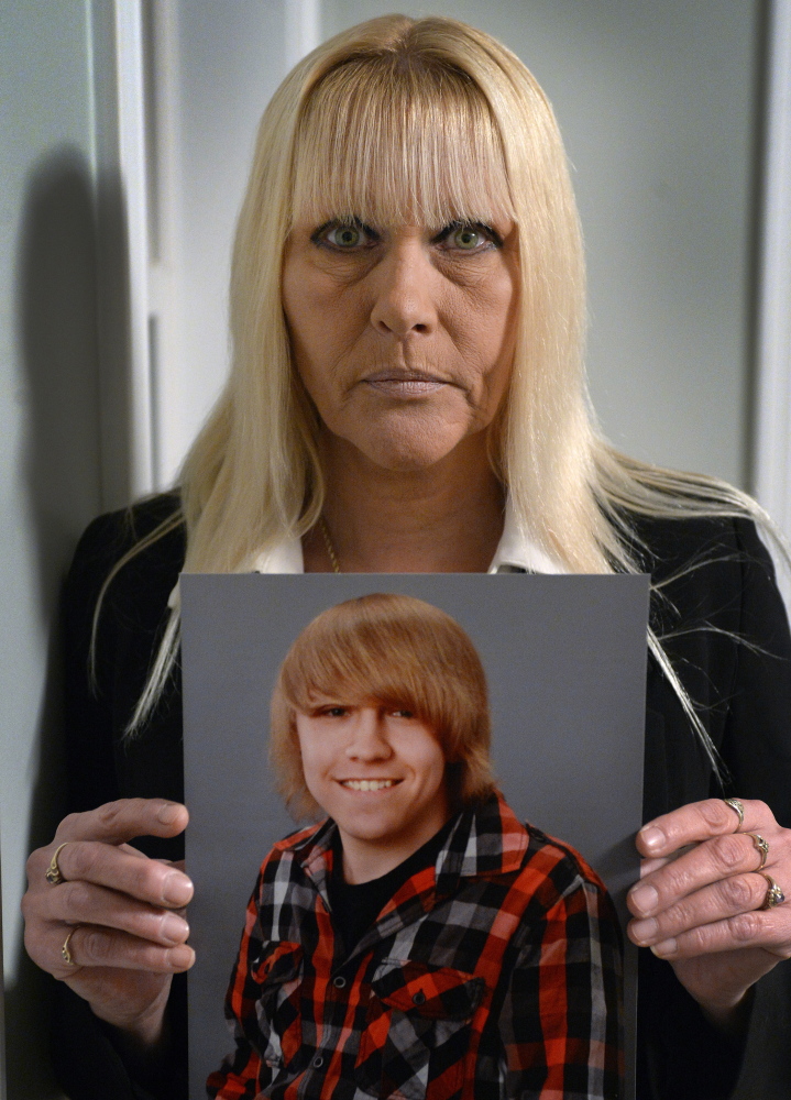 Donna Pitcher holds a photo of her 18-year-old son, Dylan Collins, which was taken this year. She said she tried all summer to have him committed to a psychiatric facility. “I did everything I could to sound the alarm,” she said. 