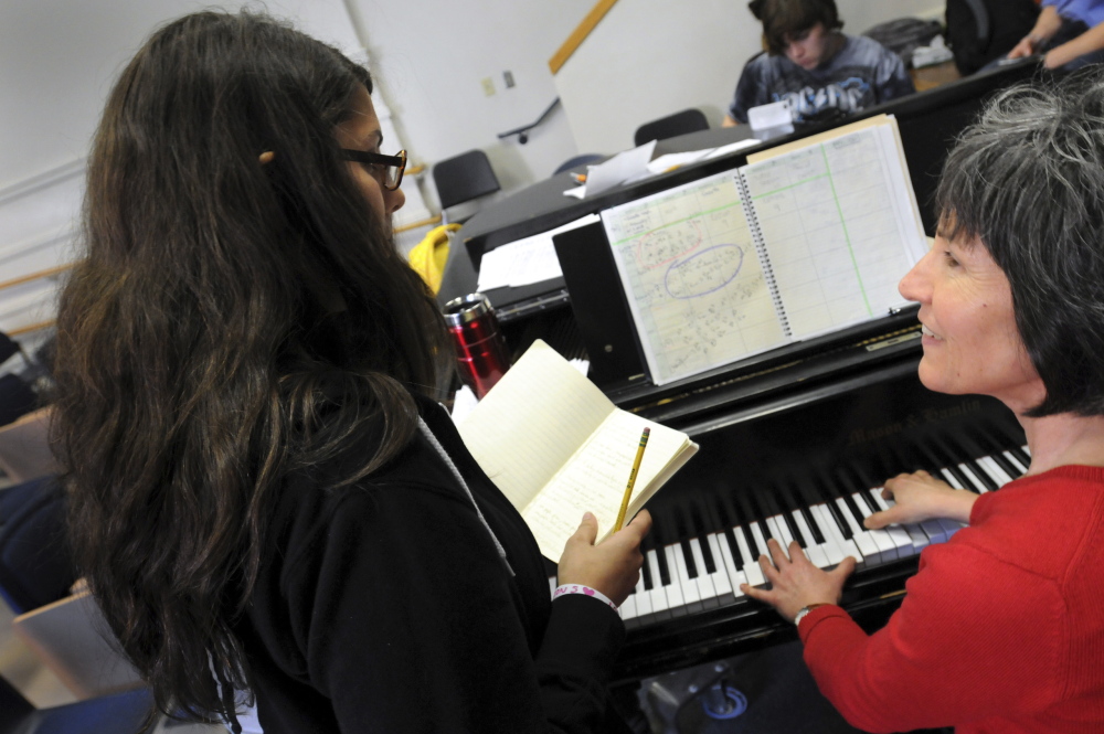 In this Nov. 19, 2014 photo, Northampton High School freshman Lexi Matuson, left, works out the right chords for her original composition with choral director Beau Flahive during a songwriting class held in the school's Little Theater in Northampton Mass. The school's new songwriting course this year gives students the opportunity to write and perform original music. (AP Photo/Daily Hampshire Gazette, Kevin Gutting)