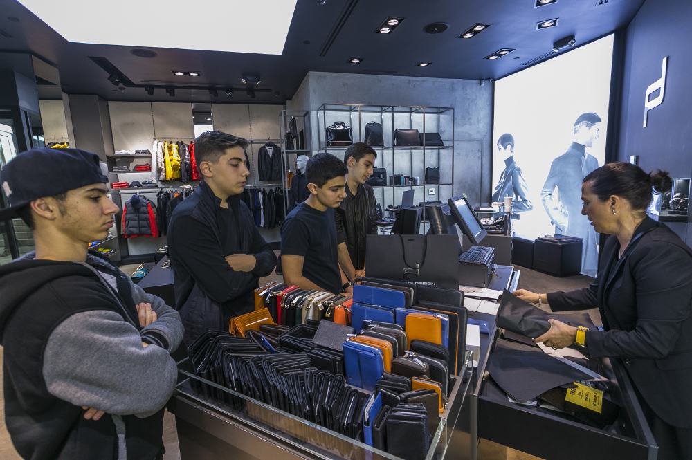 Youngsters from left, Gurgen Benyaminyan, 15, Zor Begoyan, 14, Gor Begoyan, 14, and Eduard Kyureghyan  14, shop at the Porsche Design store at the Glendale Galleria shopping mall in Glendale, Calif, Friday.