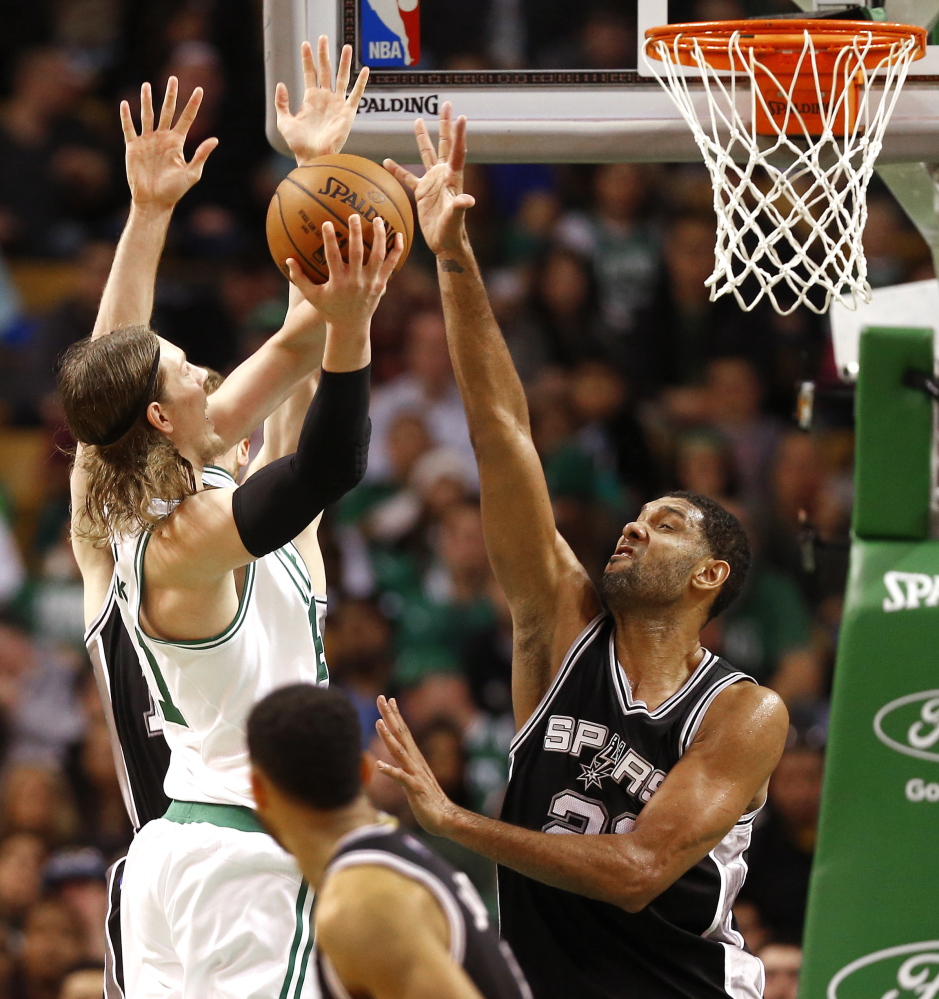 Boston’s Kelly Olynyk, left, faces the shot-blocking defense of San Antonio’s Tim Duncan during the Spurs’ 111-89 win at Boston on Sunday.