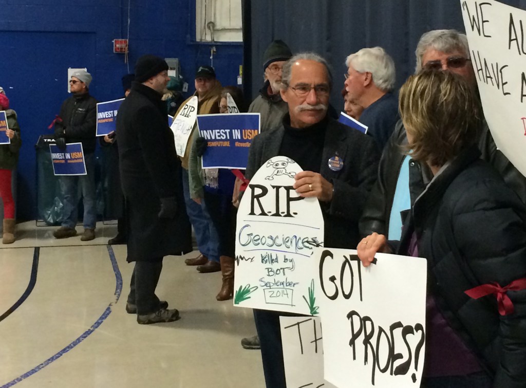 University of Southern Maine Faculty Senate Chairman Jerry Lasala, holding an RIP sigh, is among about 50 protesters who lined Sullivan Gym on the USM Portland campus, where the University of Maine System board of trustees met Sunday. Beth Quimby/Staff Writer