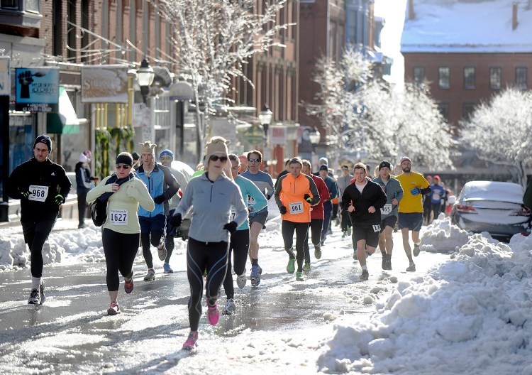 Runners make their way up Exchange Street in Portland during their 4-mile run Thursday morning.