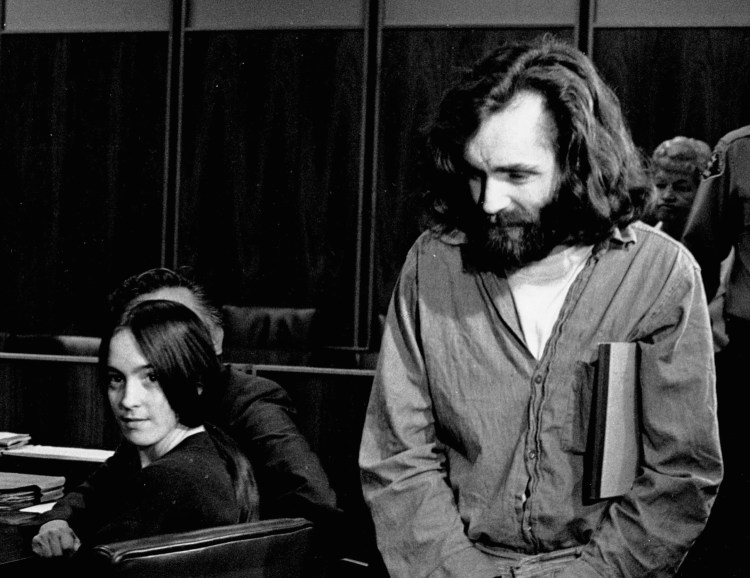 Cult leader Charles Manson walks into the courtroom as Susan Atkins, a member of his "family" of followers, looks on in Santa Monica, Calif., in 1970.  A marriage license has been issued for Manson to wed 26-year-old Afton Elaine Burton in prison.