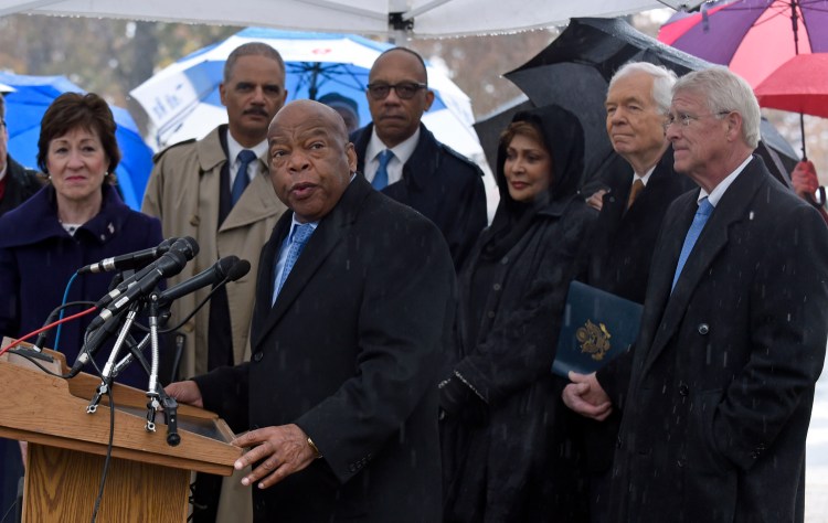 Rep. John Lewis, D-Ga., speaks before helping to plant a tree in honor of Emmett Till, a black teen killed in 1955, during a ceremony on Capitol Hill in Washington on Monday. Lewis is joined by, from left, Sen. Susan Collins, R-Maine, Attorney General Eric Holder, Eugene Robinson of the Washington Post, Janet Langhart Cohen, author of the play "Anne and Emmett" and the wife of former Maine Sen. William S. Cohen, Sen. Thad Cochran, R-Miss., and Sen. Roger Wicker, R-Miss. 