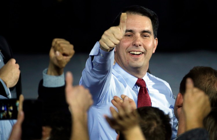 Wisconsin Republican Gov. Scott Walker greets supporters at his victory party on Tuesday in West Allis, Wis., after defeating Democratic challenger Mary Burke. The Associated Press