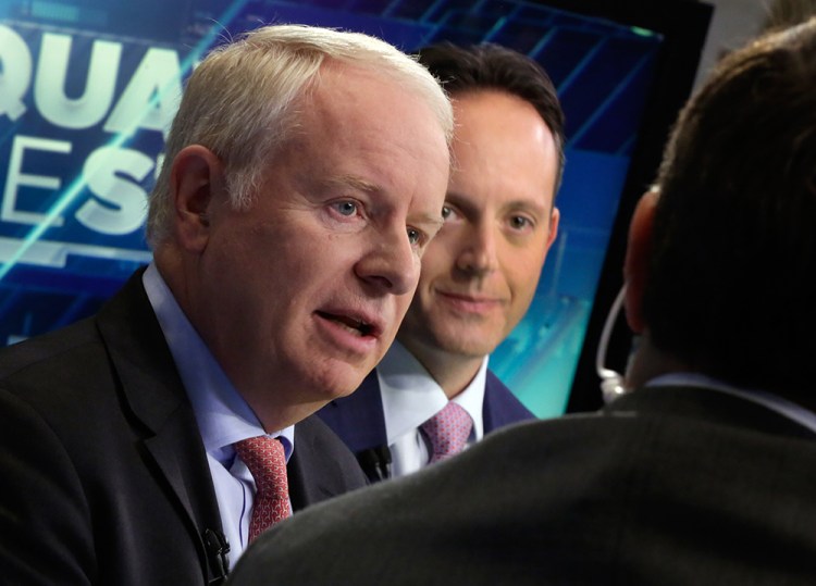 In this Nov. 17, 2014 file photo, Allergan CEO David Pyott, left, and Actavis CEO Brenton Saunders, are interviewed on the floor of the New York Stock Exchange. Pyott is set to rake in an estimated $100 million in “golden parachute” payments, according to a study done by pay-tracking firm Equilar at the request of The Associated Press. The Associated Press