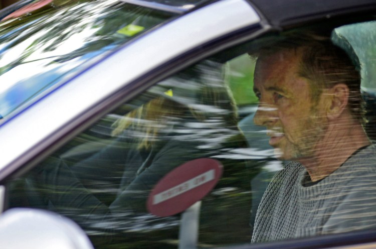 Phil Rudd, the drummer for rock band AC/DC, leaves a courthouse in Tauranga, New Zealand, Thursday after being charged with attempting to procure murder. The 60-year-old has also been charged with threatening to kill and possession of methamphetamine and marijuana.