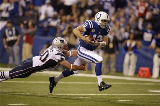 Indianapolis Colts quarterback Andrew Luck runs out of the pocket against New England Patriots defensive end Rob Ninkovich in November. The teams will meet in the AFC championship game Sunday. The Associated Press