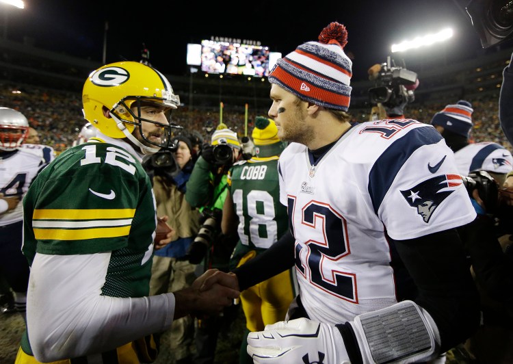 Green Bay Packers' Aaron Rodgers shakes hands with New England Patriots' Tom Brady after an NFL football game Sunday, in Green Bay, Wis. The Packers won 26-21. The Associated Press