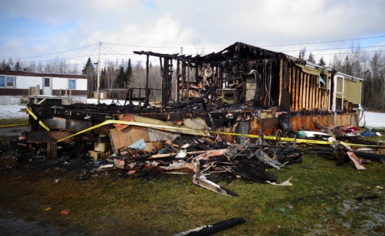 Damage is extensive to the mobile home where a mother and her three children were killed in a fire Thursday in Caribou.