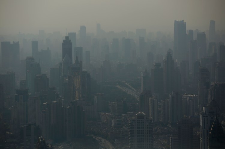Shanghai's smog-shrouded skyline as seen from the Shanghai Financial Center building on Oct. 23, 2014. China, whose emissions are growing as it builds new coal plants, has set a target for its emissions to peak by about 2030 — earlier if possible. Reuters