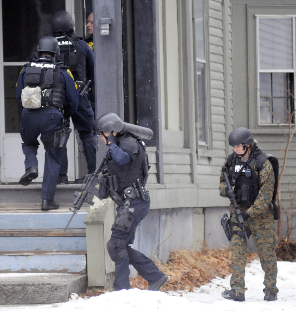 Augusta police tactical team members enter 388 Water St. to apprehend Lorne Sherwood on Tuesday.
Andy Molloy/Kennebec Journal