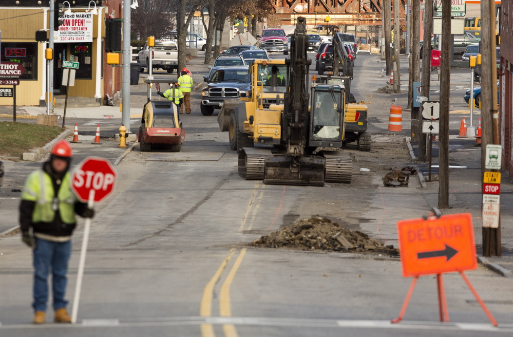 Construction crews do sewer work on Elm Street in Biddeford last month. Although some road repair and sewer projects are in the city’s budget, officials say additional work needs to be done on 35 miles of roads and stormwater-sewer line separation.