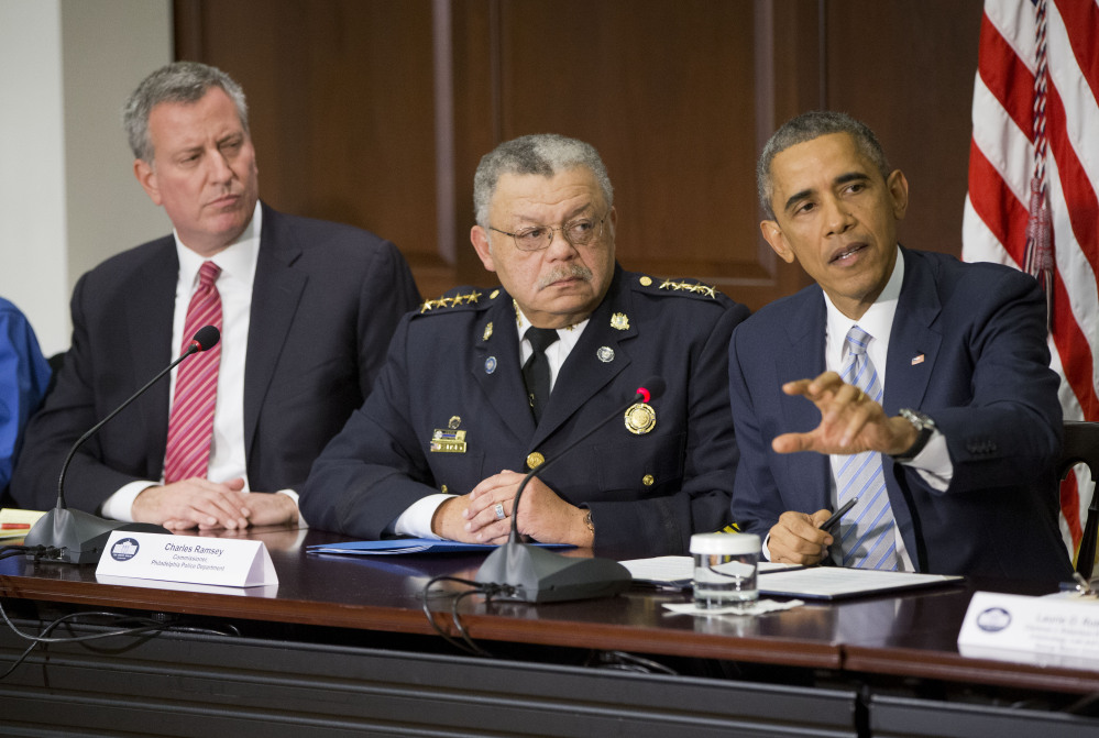 President Obama speaks during his meeting with elected officials, law enforcement officials and community and faith leaders in Washington on Monday. Obama said that in the wake of the shooting of an unarmed 18-year-old in Ferguson, Missouri, he wants to build trust between police and the communities they serve. Sitting with Obama are New York Mayor Bill de Blasio, left, and Philadelphia Police Commissioner Charles Ramsey.