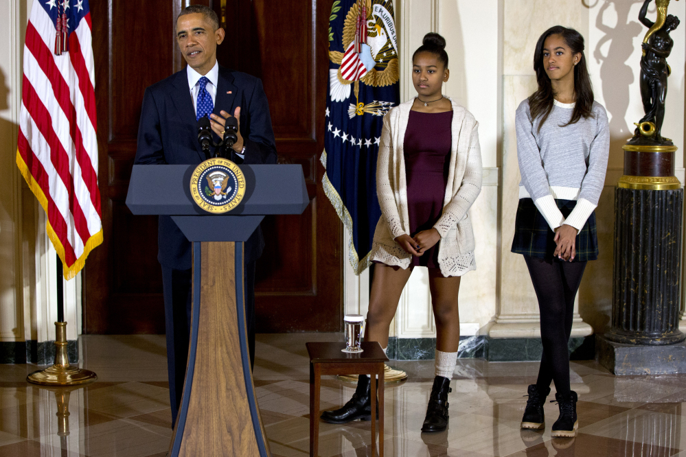 President Barack Obama, joined by his daughters Malia, right, and Sasha, center, speaks at the White House on Nov. 26 during the presidential turkey pardon ceremony, an annual Thanksgiving tradition.